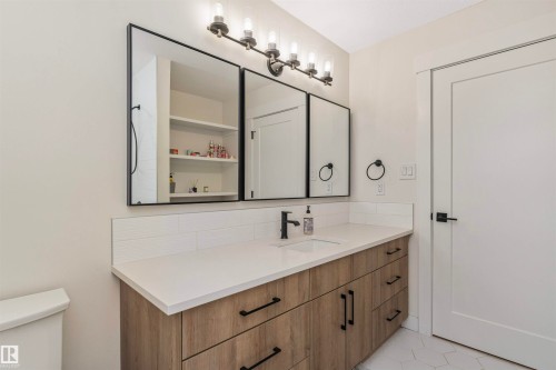 Bathroom featuring a light wood-finish vanity with a white countertop and integrated sink - 627 Forest Lane, Edmonton, AB - Indoor Photo Showing Bathroom