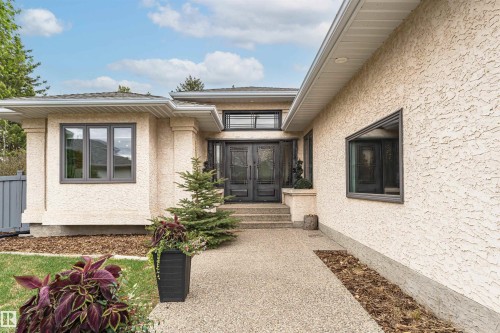 Stucco exterior featuring dark framed windows and a double entry door - 627 Forest Lane, Edmonton, AB - Outdoor