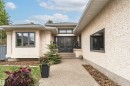 Stucco exterior featuring dark framed windows and a double entry door - 627 Forest Lane, Edmonton, AB  - Outdoor 