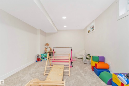 Finished lower-level space featuring recessed lighting, light-toned carpeting, and a window with white trim - 627 Forest Lane, Edmonton, AB - Indoor