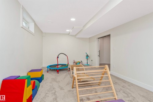 Carpeted room with recessed lighting and a single window, featuring neutral wall tones and white trim - 627 Forest Lane, Edmonton, AB - Indoor Photo Showing Other Room