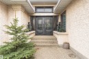 Architectural entrance featuring double black doors with decorative glass panels, a transom window with grille, and flanking sidelights - 627 Forest Lane, Edmonton, AB  - Outdoor 