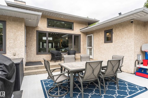Exterior patio featuring a concrete surface, stucco siding, and a multi-pane glass door - 627 Forest Lane, Edmonton, AB - Outdoor With Deck Patio Veranda With Exterior