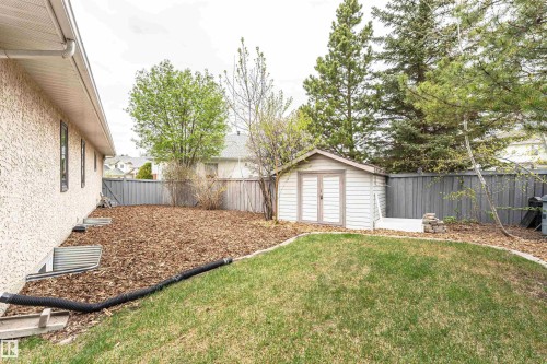 Spacious backyard featuring a manicured lawn, wood chip landscaping, and a fenced perimeter - 627 Forest Lane, Edmonton, AB - Outdoor