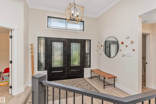 Grand entryway featuring double entry doors with decorative glass panels and a transom window above - 627 Forest Lane, Edmonton, AB - Indoor Photo Showing Other Room