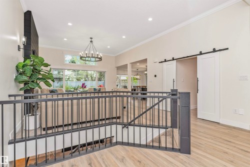 Upper level landing featuring wood-finish flooring and a black metal railing - 627 Forest Lane, Edmonton, AB - Indoor Photo Showing Other Room