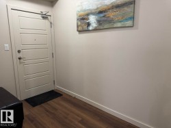 Solid core entry door with four horizontal panels and brushed nickel hardware - 