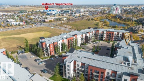 Modern multi-story residential building featuring a flat roofline and integrated parking - 228 308 Ambleside Link Sw, Edmonton, AB - Outdoor With View