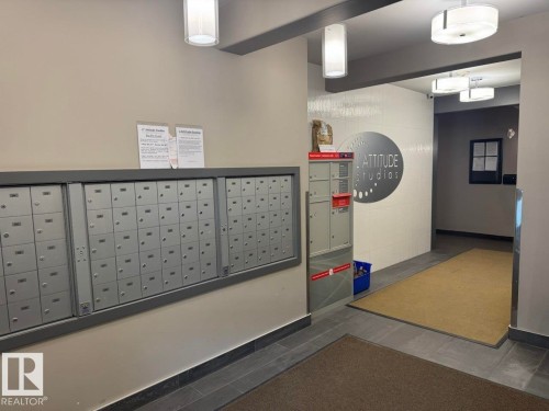 Mailbox area featuring multiple individual mail slots and parcel lockers - 228 308 Ambleside Link Sw, Edmonton, AB - Indoor Photo Showing Other Room