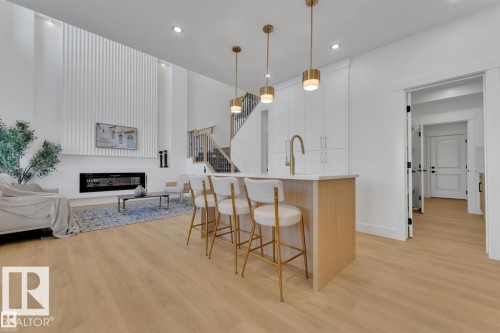 Open-concept living area with light wood-finish flooring - 1129 Starling Drive, Edmonton, AB 