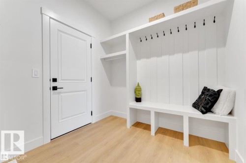 Built-in storage bench with overhead shelving and coat hooks - 1129 Starling Drive, Edmonton, AB 