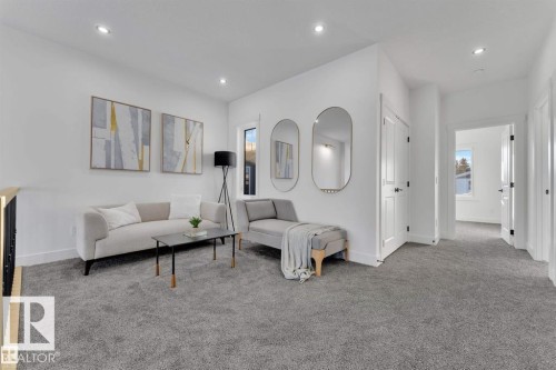 Carpeted second-floor landing featuring recessed lighting, white walls, and white trim - 1129 Starling Drive, Edmonton, AB 