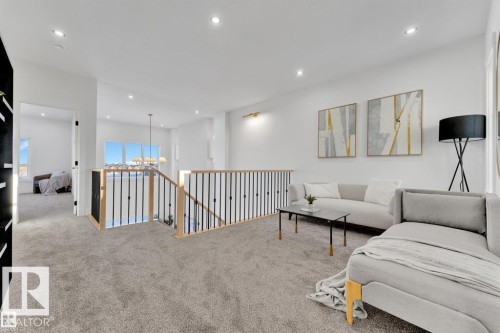 Upper-level landing featuring light-toned carpeting and recessed lighting - 1129 Starling Drive, Edmonton, AB 