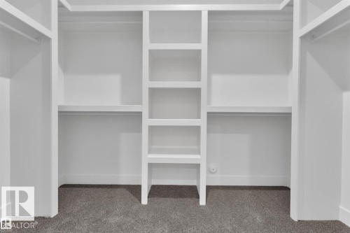 Integrated closet system featuring white shelving and hanging rods - 1129 Starling Drive, Edmonton, AB 