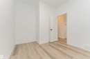 This room features light-toned plank flooring and crisp white walls, providing a neutral aesthetic - 2355 Egret Way, Edmonton, AB  - Indoor Photo Showing Other Room 