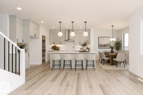 The property features an open-concept living area with light-toned flooring throughout - 2355 Egret Way, Edmonton, AB - Indoor