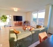 Spacious living area featuring light wood-finish flooring and ample natural light - 807 10011 116 Street, Edmonton, AB  - Indoor Photo Showing Living Room 