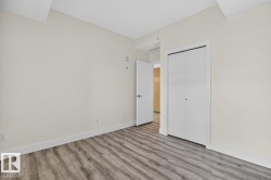Interior room with light neutral wall paint and wood-finish flooring - 