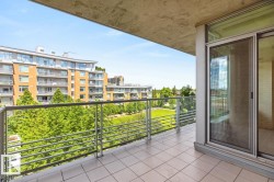 Outdoor balcony with tile flooring, glass and metal railing, and sliding glass doors - 
