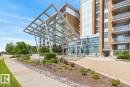 Modern high-rise building with a grand glass entrance and metal canopy - #407 2504 109 St Nw, Edmonton, AB  - Outdoor With Balcony With Facade 