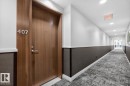 Long hallway with recessed lighting and a patterned carpet - #407 2504 109 St Nw, Edmonton, AB  - Indoor Photo Showing Other Room 