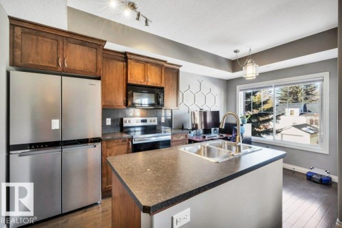 205 6720 112 Street, Edmonton, AB - Indoor Photo Showing Kitchen With Stainless Steel Kitchen With Double Sink