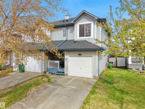 Two-story home with light blue siding, an attached garage, a peaked roofline, and a prominent second-story window - 16121 131A Street, Edmonton, AB - Outdoor