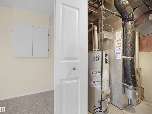 Utility closet featuring a water heater, furnace, and exposed ductwork - 16121 131A Street, Edmonton, AB - Indoor Photo Showing Basement