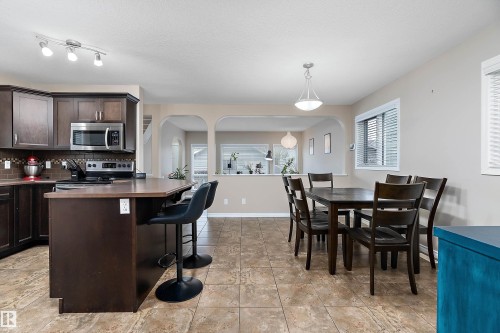 Open-concept kitchen and dining area featuring ceramic tile flooring - 2007 74 Street, Edmonton, AB - Indoor