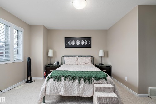 Room featuring light neutral wall paint, white trim, and light-colored carpet flooring - 2007 74 Street, Edmonton, AB - Indoor Photo Showing Bedroom