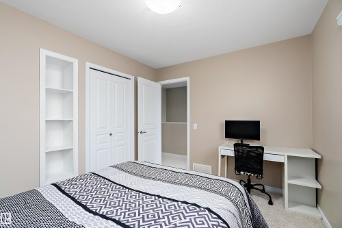 Bedroom featuring light-colored walls and carpeted flooring - 2007 74 Street, Edmonton, AB - Indoor Photo Showing Bedroom