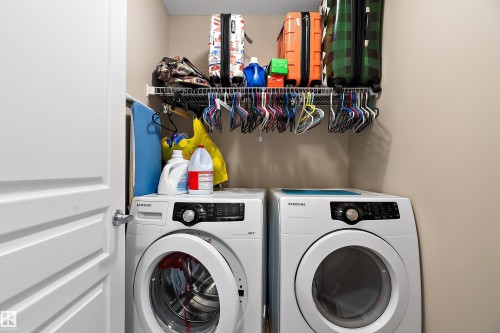Dedicated laundry area featuring a white front-load washer and dryer set - 2007 74 Street, Edmonton, AB - Indoor Photo Showing Laundry Room