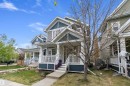 Two-story residential architecture featuring a covered front porch with white railings, grey siding, and a concrete walkway - 2007 74 Street, Edmonton, AB  - Outdoor With Deck Patio Veranda 