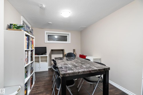 Bedroom converted to a games room  featuring wood-finish flooring, a recessed window, and a flush-mount ceiling light - 2007 74 Street, Edmonton, AB - Indoor Photo Showing Dining Room