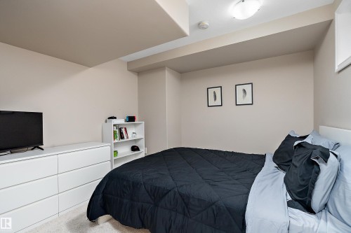 Bedroom featuring light-colored walls and soft carpet flooring - 2007 74 Street, Edmonton, AB - Indoor Photo Showing Bedroom