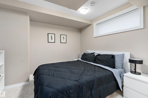 Neutral-toned room featuring a window with blinds, recessed lighting, and a flush mount ceiling light - 2007 74 Street, Edmonton, AB - Indoor Photo Showing Bedroom