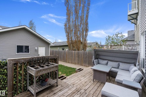 Outdoor wood deck featuring a lattice privacy screen and a dedicated grassy area - 2007 74 Street, Edmonton, AB - Outdoor With Deck Patio Veranda With Exterior