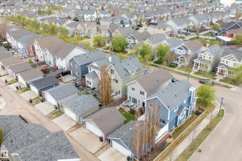 Residential street featuring multiple properties with varied architectural styles and front-facing attached garages - 2007 74 Street, Edmonton, AB - Outdoor With View