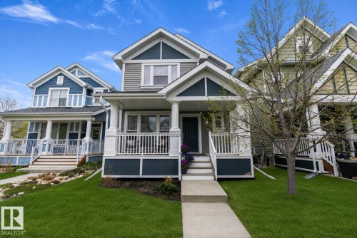 Two-story residence featuring a covered front porch with white railings and columns - 2007 74 Street, Edmonton, AB - Outdoor With Deck Patio Veranda With Facade