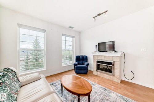 309 1003 Gault Boulevard, Edmonton, AB - Indoor Photo Showing Living Room With Fireplace