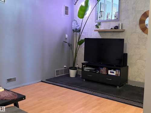 Neutral-toned walls complement wood-finish flooring - 4108 49 Avenue, Bonnyville Town, AB - Indoor Photo Showing Other Room