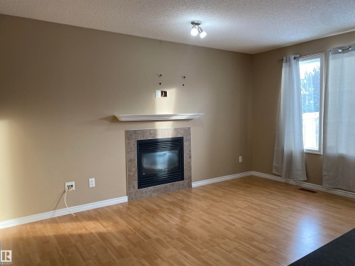6411 18 Avenue, Edmonton, AB - Indoor Photo Showing Living Room With Fireplace