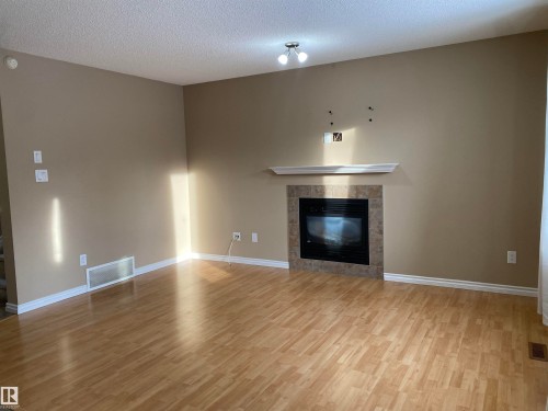 6411 18 Avenue, Edmonton, AB - Indoor Photo Showing Living Room With Fireplace