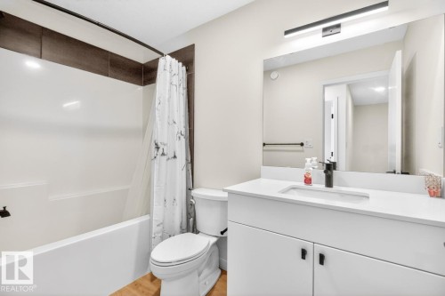 Bathroom featuring a white vanity with a rectangular undermount sink, a white countertop, and matte black fixtures - 17347 100 Street, Edmonton, AB - Indoor Photo Showing Bathroom