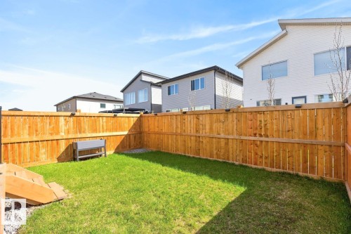 Enclosed backyard featuring a manicured lawn, full privacy fencing, and a built-in planter box - 17347 100 Street, Edmonton, AB - Outdoor
