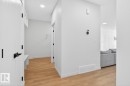 Entryway featuring wood-finish flooring, white walls, recessed ceiling lighting, and a built-in storage bench with shelving - 17347 100 Street, Edmonton, AB  - Indoor Photo Showing Other Room 