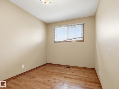 Room featuring wood-finish flooring and neutral painted walls - 13504 116 St Nw, Edmonton, AB - Indoor Photo Showing Other Room