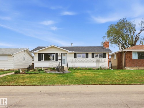 White siding residence featuring black window shutters and a dark shingle roof - 13504 116 St Nw, Edmonton, AB - Outdoor