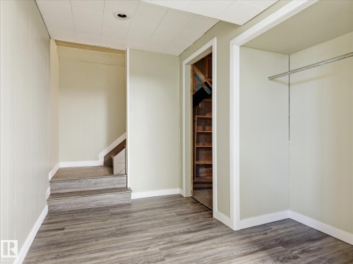 Spacious interior area featuring wood-finish flooring, light-colored walls, and a recessed ceiling light - 13504 116 St Nw, Edmonton, AB - Indoor Photo Showing Other Room