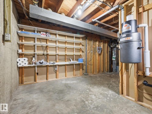 Unfinished basement space featuring exposed wood framing, concrete floor, and overhead ductwork - 13504 116 St Nw, Edmonton, AB - Indoor Photo Showing Basement